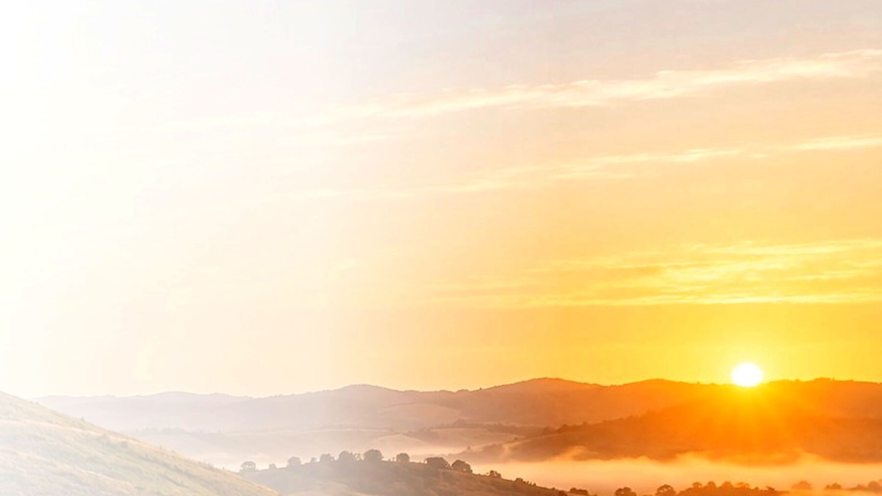 Sunset over rolling hills